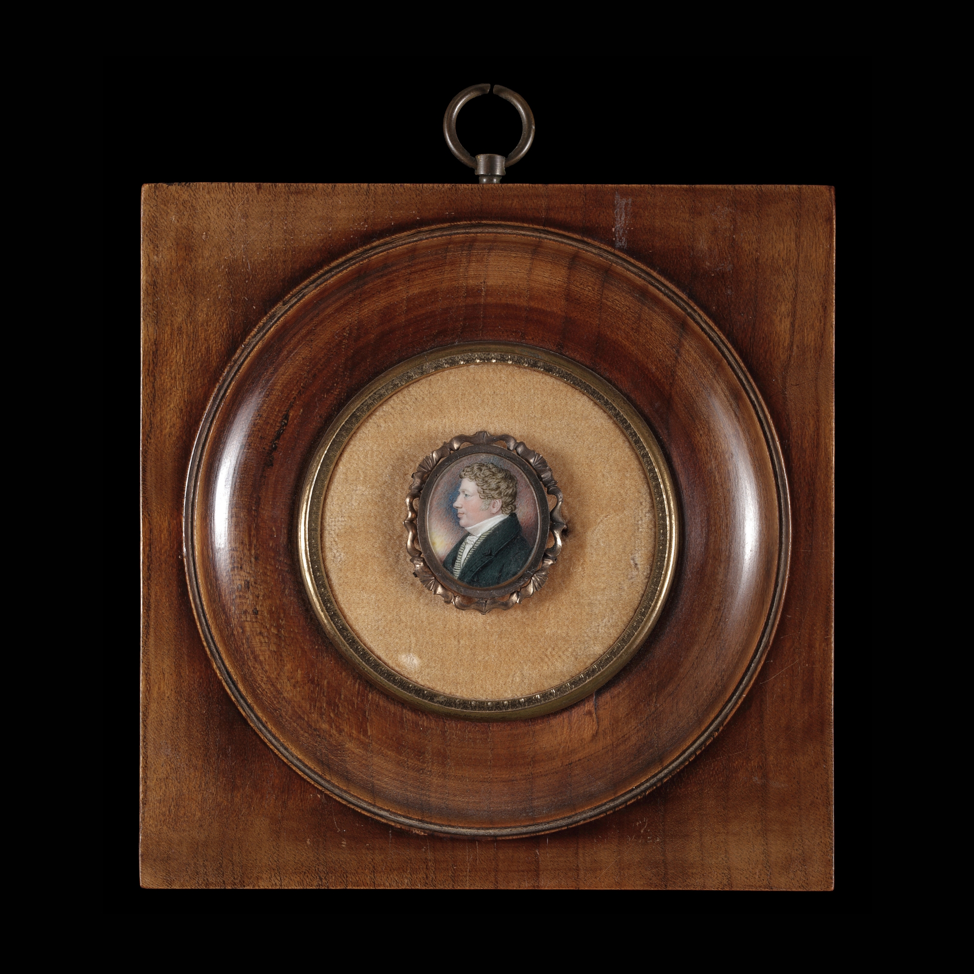 Portrait miniature of a Gentleman in profile to his right, wearing a black coat with a striped cream waistcoat, white shirt and white cravat